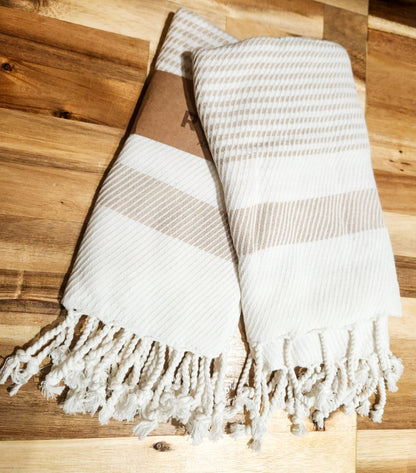 Cotton hand towels with beige stripes overlapped.